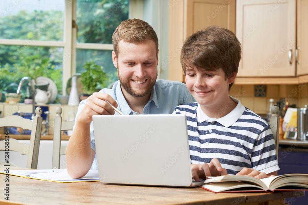 Male Home Tutor Helping Teenage Boy With Studies Male Home Tutor Helping Teenage Boy With Studies