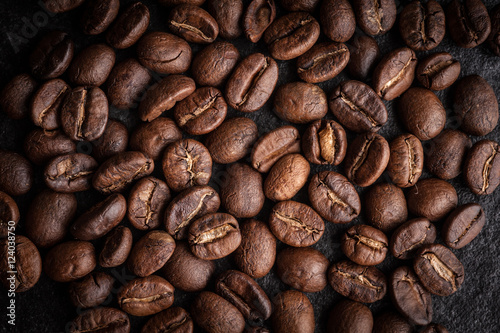roasted coffee beans on dark background, can be used as a background © kamon_saejueng