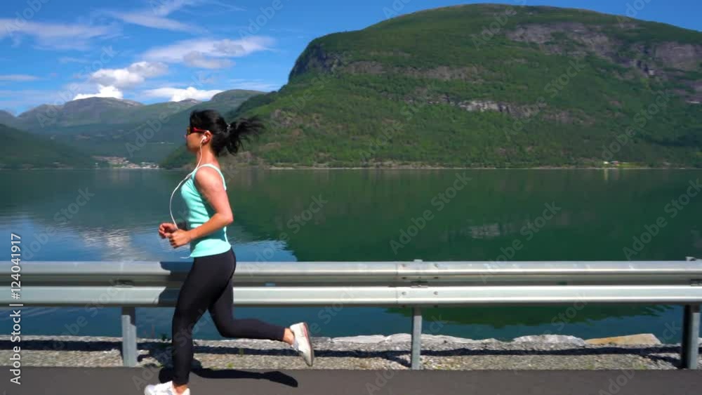 Woman jogging outdoors. Norwegian fjord.
