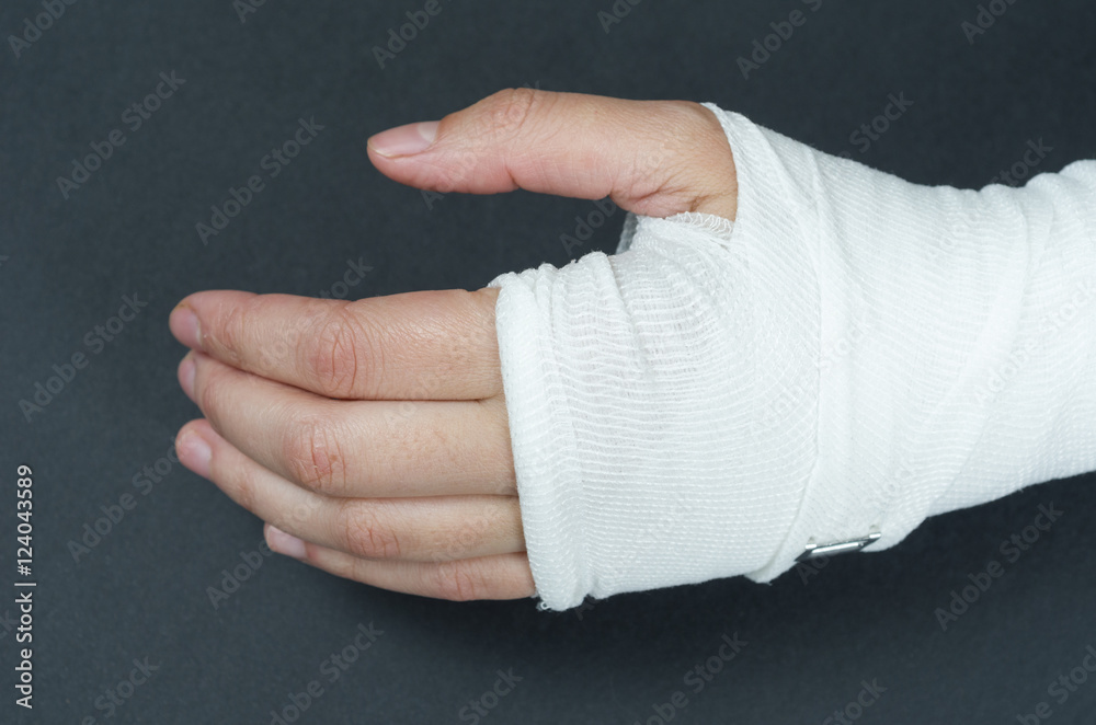Hand tied elastic bandage on a black background Photos | Adobe Stock