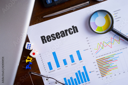 Magnifying glass on colourful pie chart with 