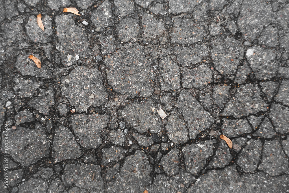 Texture of old, cracked asphalt. The old road