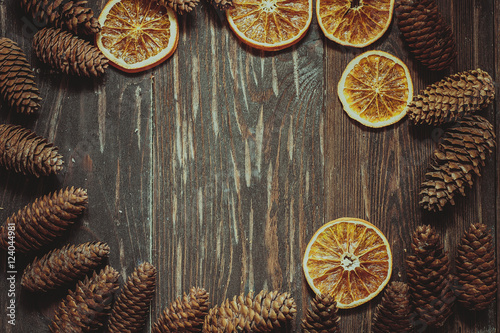 dark wood background with cones and dry orange with copy space