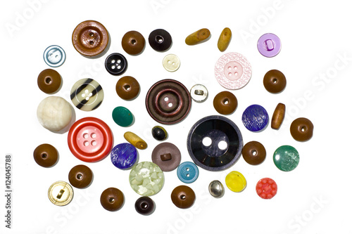 Multi-colored buttons and beads on white background.