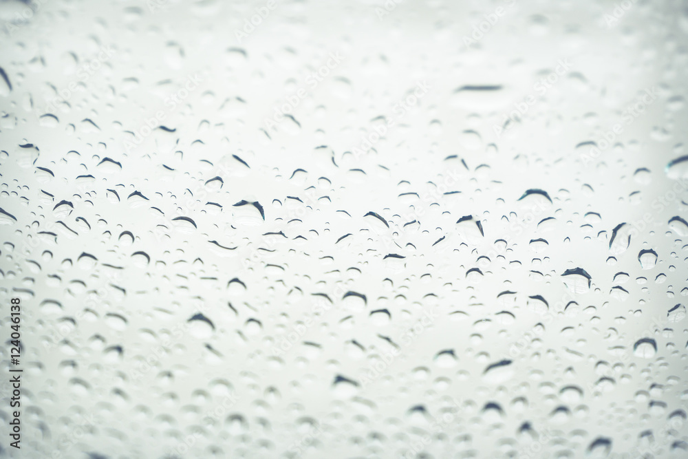 Rain drop on glass window background.(Processed in vintage colour tone) Rain drop on glass window background.(Processed in vintage colour tone)