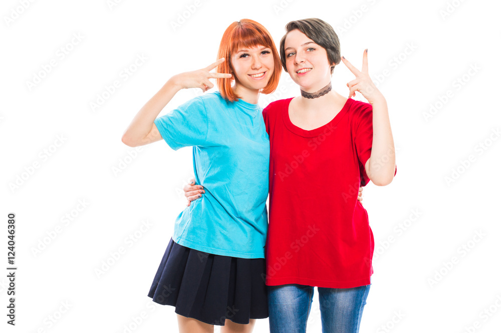 Two Lesbian Girls Hugging And Shows A Peace Sign On Their Fingers On White Isolated Background