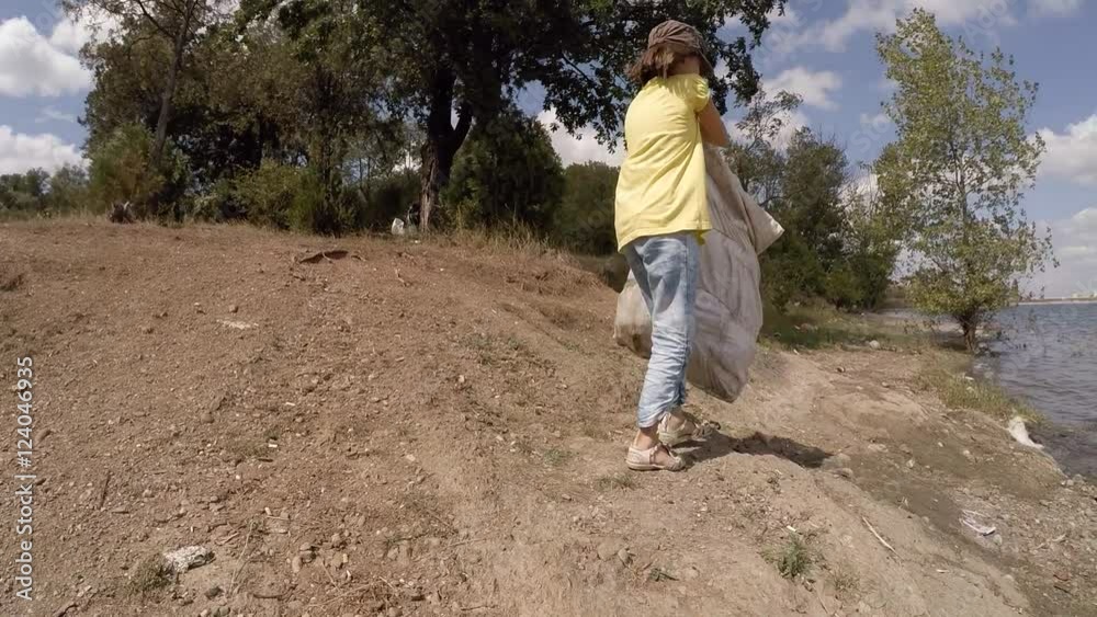 girl cleaning a park from trash, slow motion girl cleaning a park from trash, slow motion