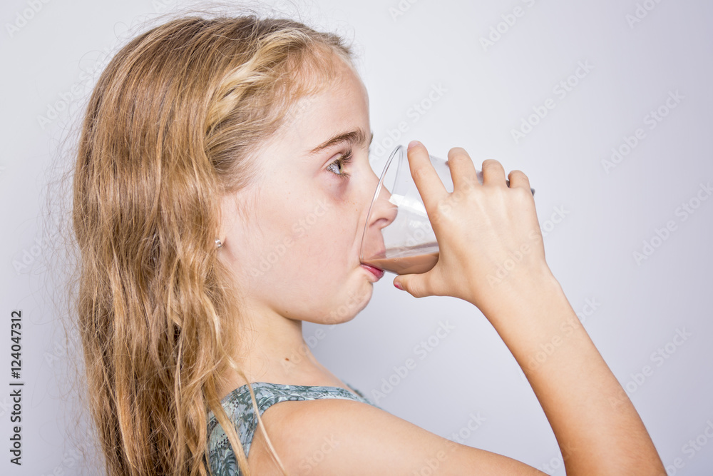 Happy smiling child drinking chocolate milk isolated on white Happy smiling child drinking chocolate milk isolated on white