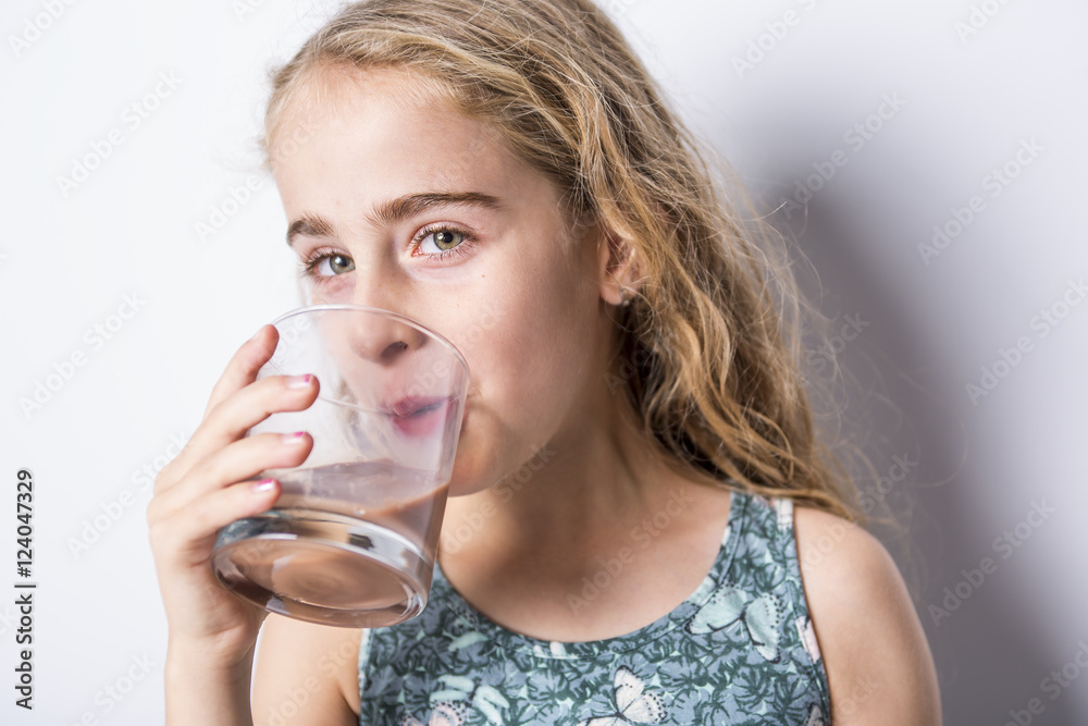 Happy smiling child drinking chocolate milk isolated on white Happy smiling child drinking chocolate milk isolated on white