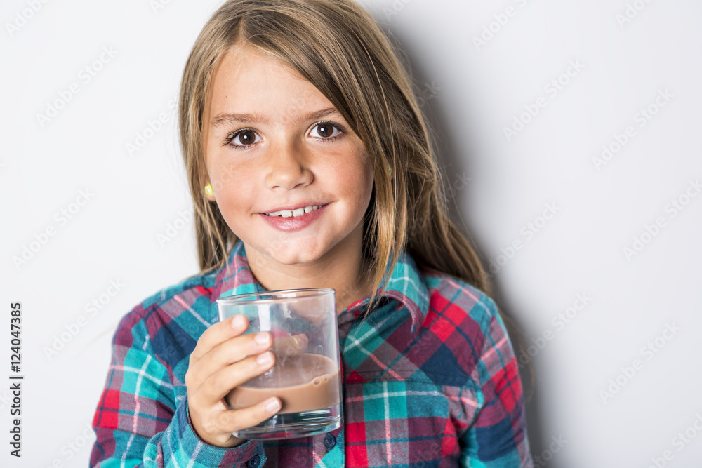 Happy smiling child drinking chocolate milk isolated on white Happy smiling child drinking chocolate milk isolated on white