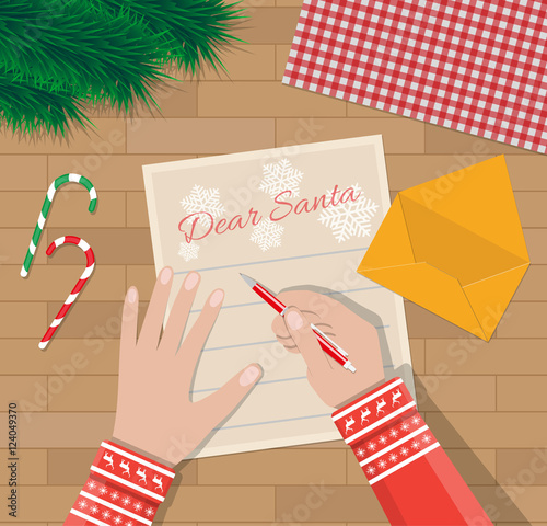 Child Hand with pen Writing letter to santa claus