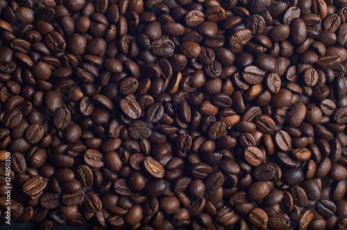 Dark brown coffee beans on the table. Background from coffee beans.