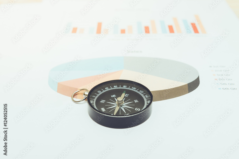 business navigation concept with compass and diagram or graph