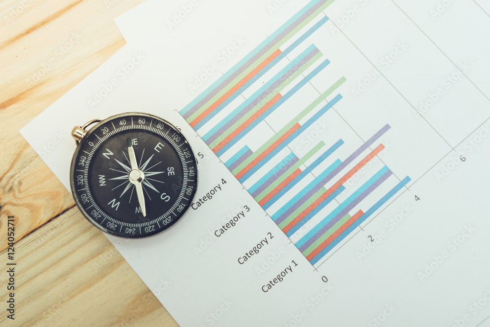 business navigation concept with compass and diagram or graph business navigation concept with compass and diagram or graph