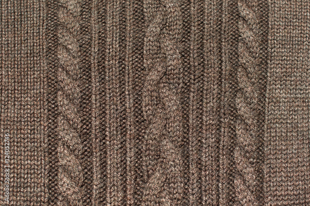 Texture of brown knitted wool sweater with ornament