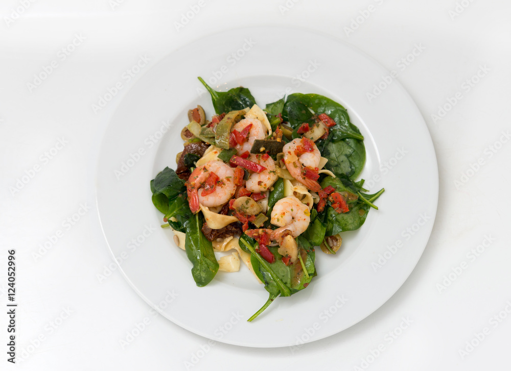 close up on fresh salad of prawns, pasta, baby spinach and chili, top view close up on fresh salad of prawns, pasta, baby spinach and chili, top view