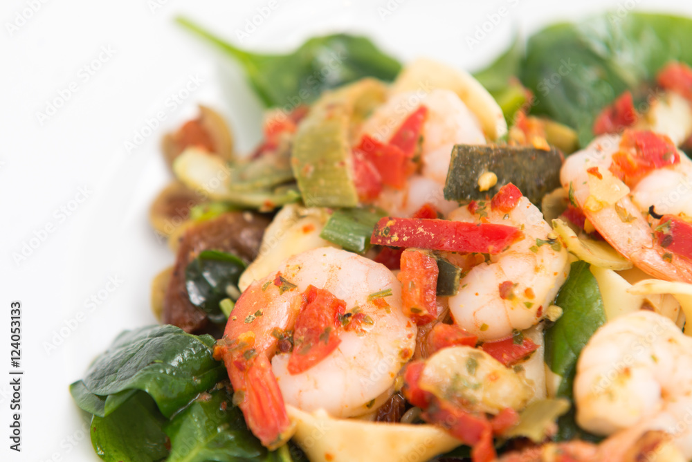 close up on fresh salad of prawns, baby spinach and chili, on white close up on fresh salad of prawns, baby spinach and chili, on white