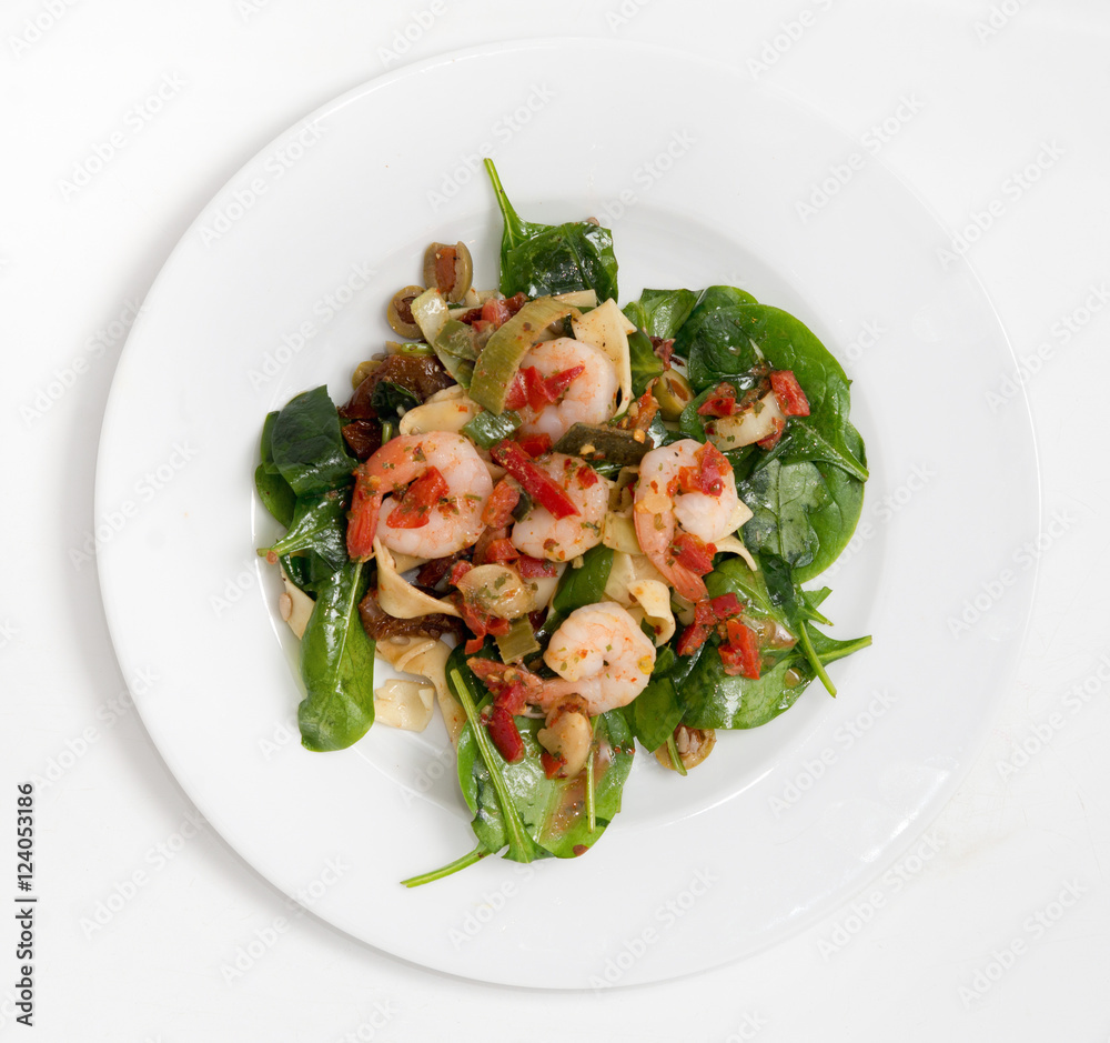close up on fresh salad of prawns, baby spinach and chili,  top view