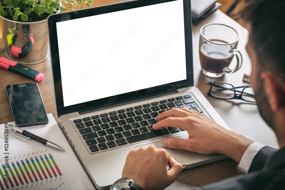 © Rawf8 - Man working on a laptop with blank screen