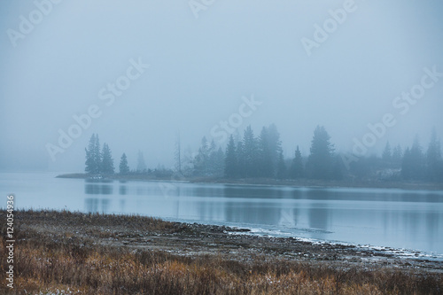 Islands In The Evening Fog At Astotin Lake; Edmonton, Alberta, Canada photo