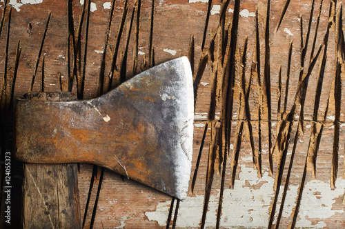 Vintage axe lies on a wooden billet. Huge axe for a strong and manly lumberjack. A piece of fresh wood.
