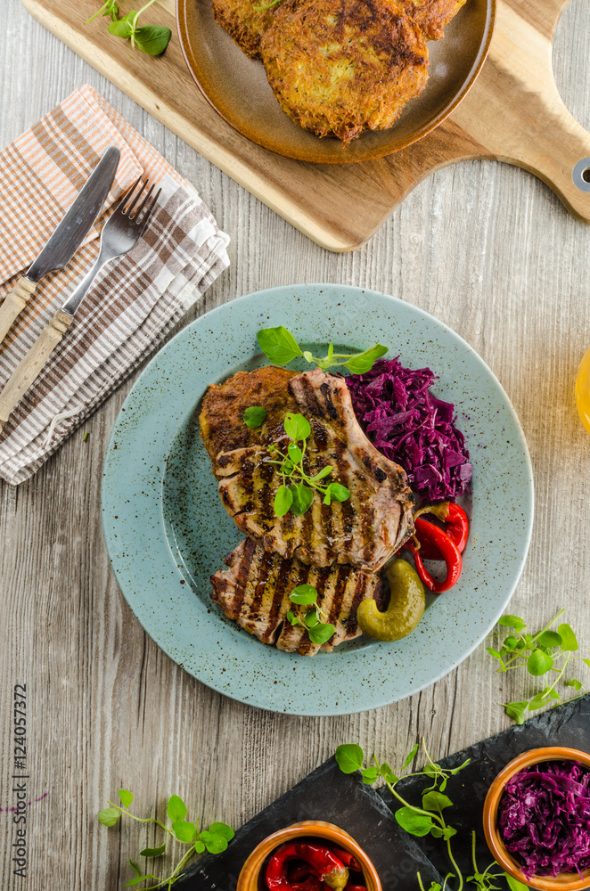 Grilled pork chops with herbs and garlic, potato pancakes