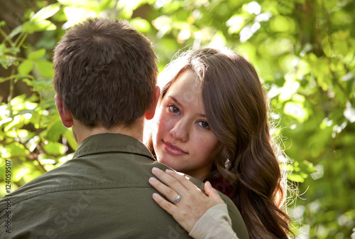 Newlywed Couple Embracing In A Park; Edmonton, Alberta, Canada