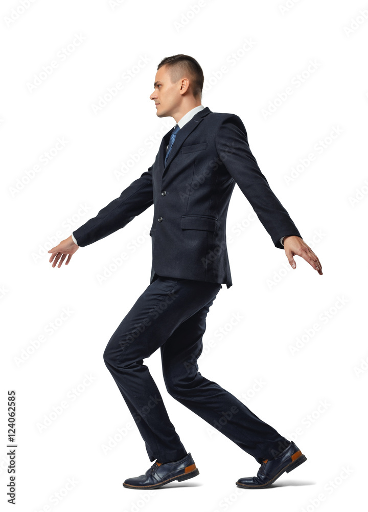 Full growth portrait of businessman walking tightrope isolated on white background