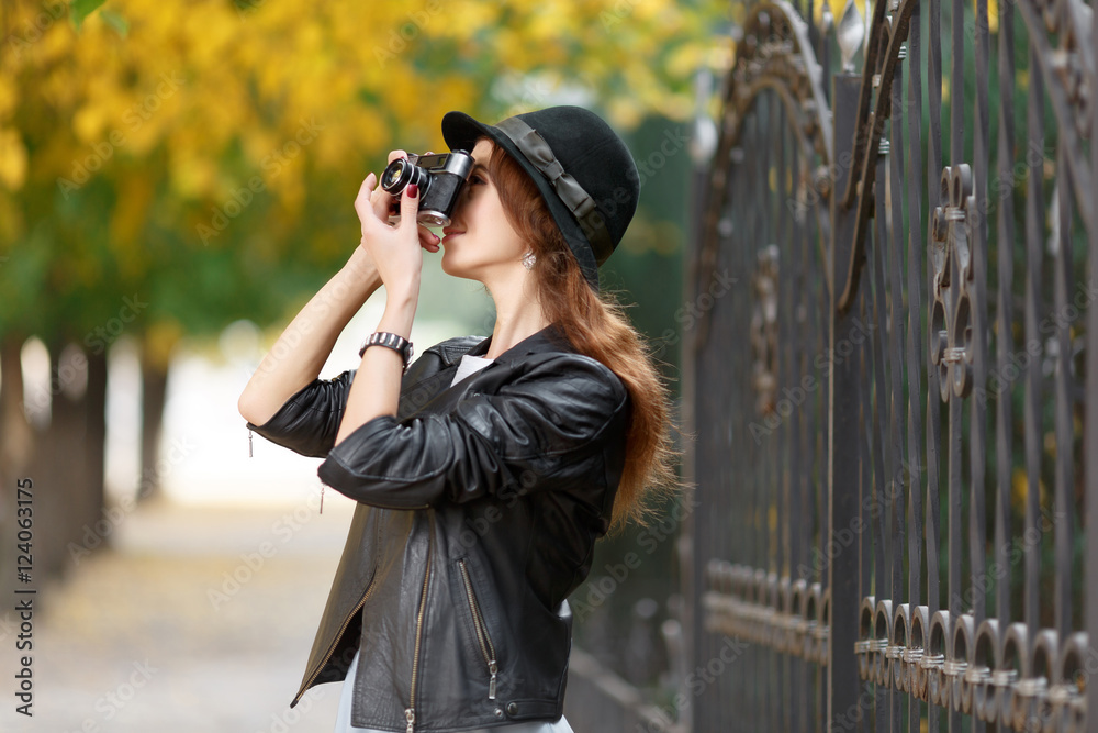 Young girl with camera outdoors