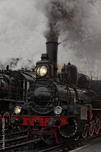 Old steam locomotive. Low key photo. Vintage style.