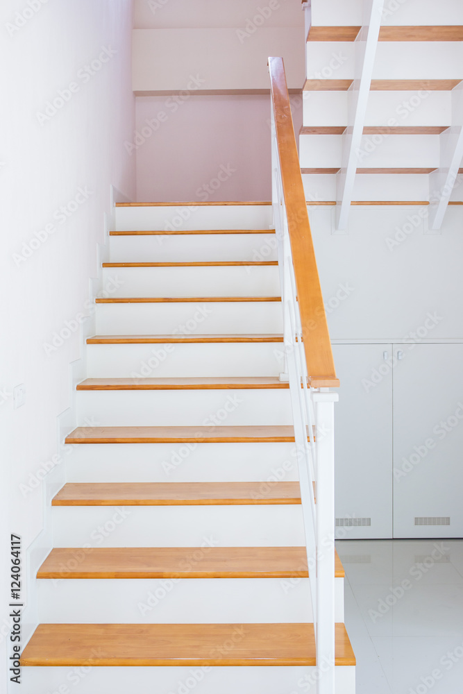 The modern wooden stair way in home close up. The modern wooden stair way in home close up.