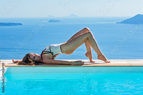 Woman in swimsuit sunbathing lying