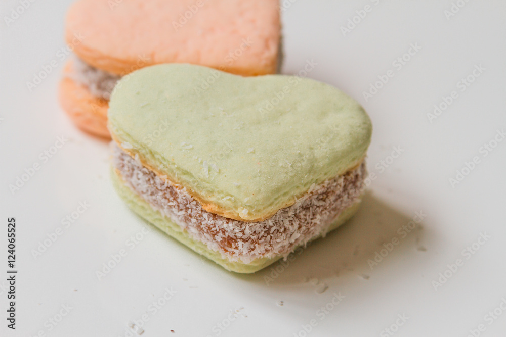 Two color alfajores cornstarch with heart shape on white backgro