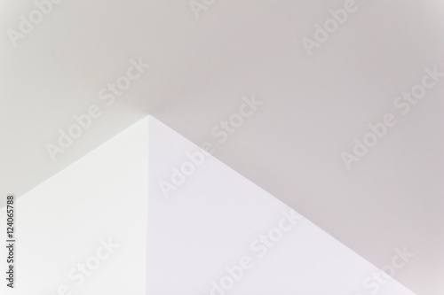 Construction details: Plastered board ceiling and wall corner with reflecting of fluorescent light