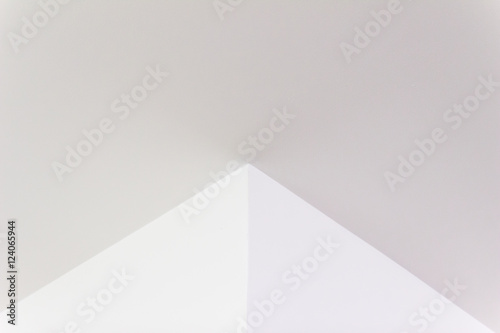 Construction details: Plastered board ceiling and wall corner with reflecting of fluorescent light