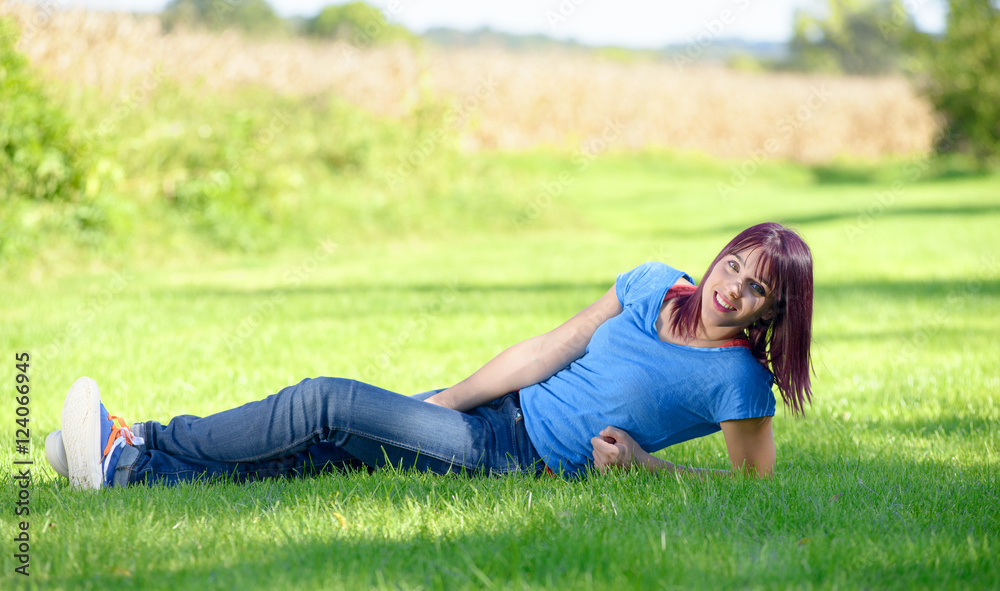 beautiful young woman in jeans lying on the grass beautiful young woman in jeans lying on the grass