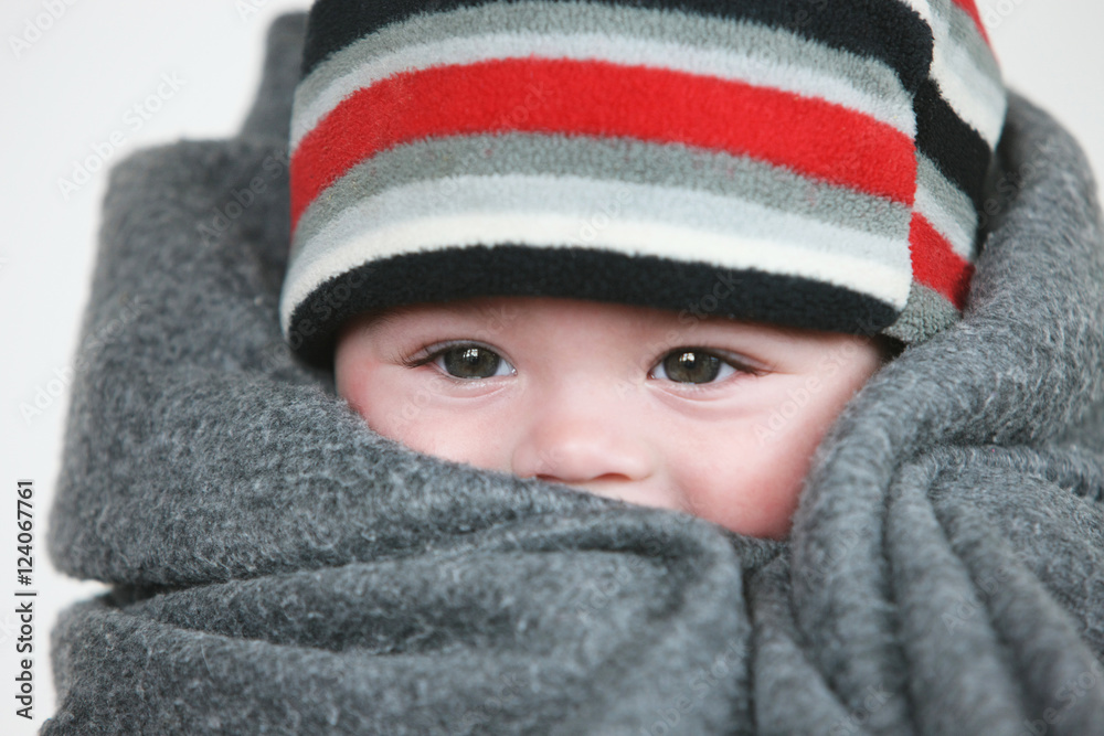 Baby Wrapped In A Grey Blanket With A Striped Hat; Troutdale, Oregon, United States of America Baby Wrapped In A Grey Blanket With A Striped Hat; Troutdale, Oregon, United States of America