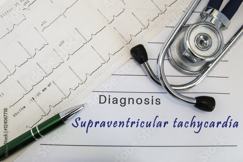 Diagnosis of Supraventricular tachycardia. Stethoscope, green pen and electrocardiogram lie on medical form with diagnosis of Supraventricular tachycardia on the desk in the office of cardiologist
