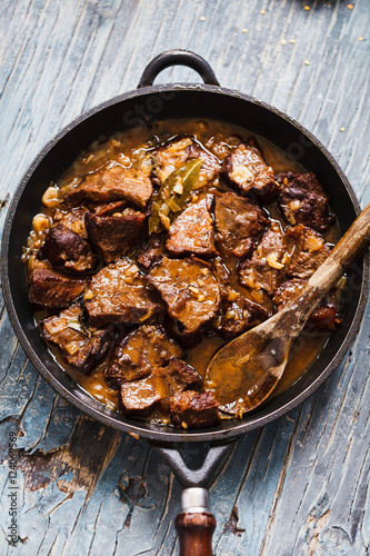 Braised beef stew. Overhead of braised beef caramelized sauce. 