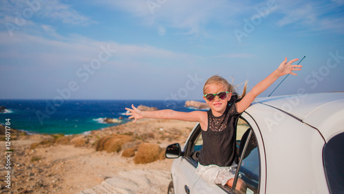 Little girl on vacation travel by car. Summer holiday and car travel concept