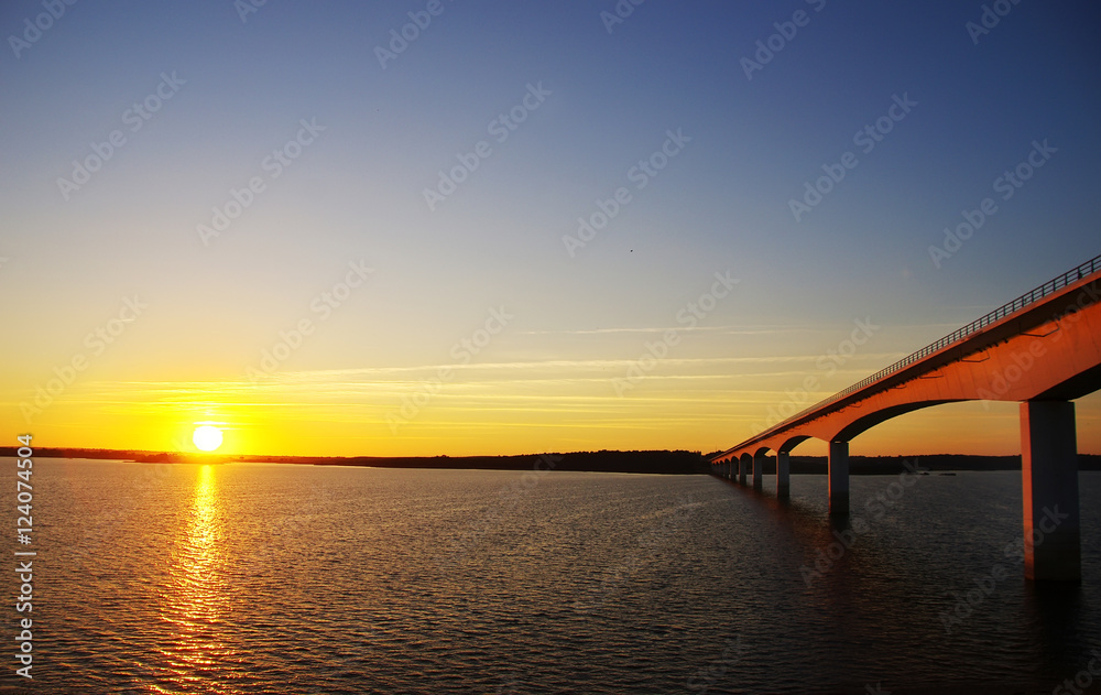 sunset in alqueva lake and bridge