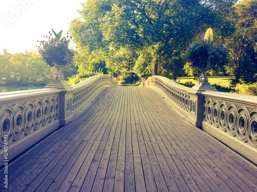 walkway of Bow bridge in vintage style at Central Park, Manhattan, New York photo