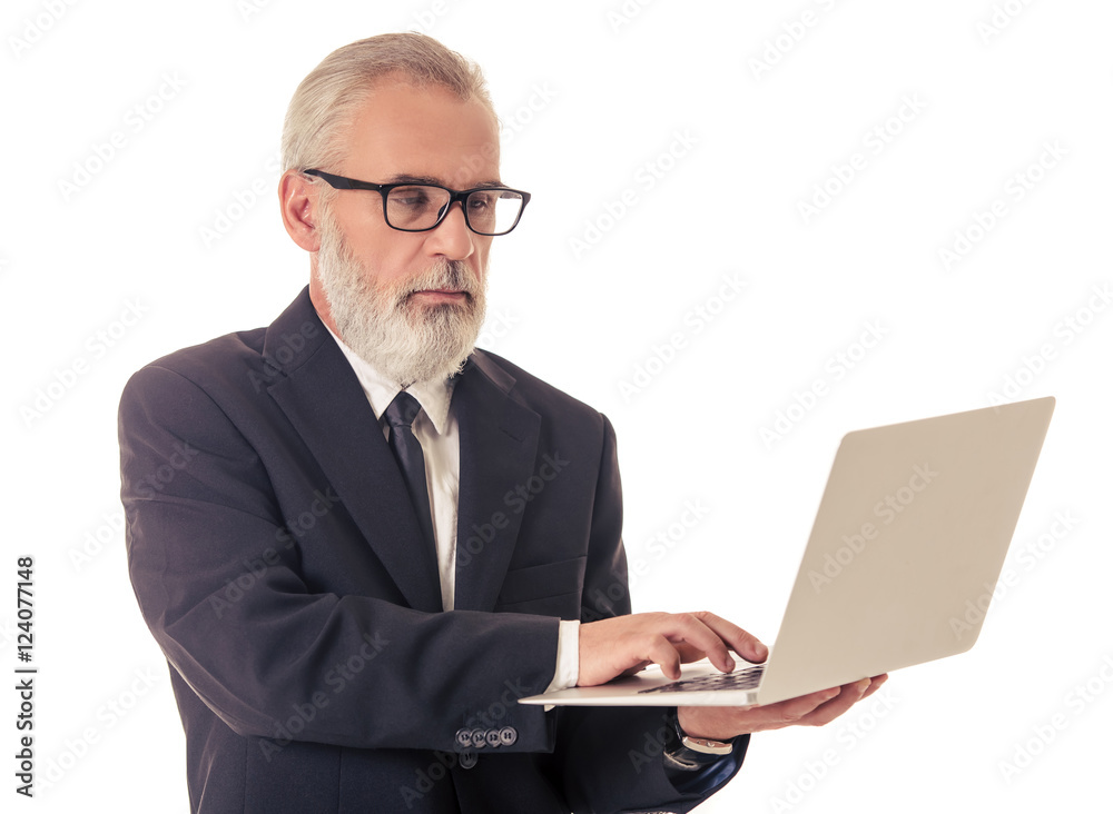 Handsome mature businessman with gadget Handsome mature businessman with gadget