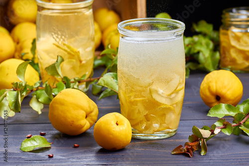 carbonated drink with syrup of japanese quince on fresh  fruits background