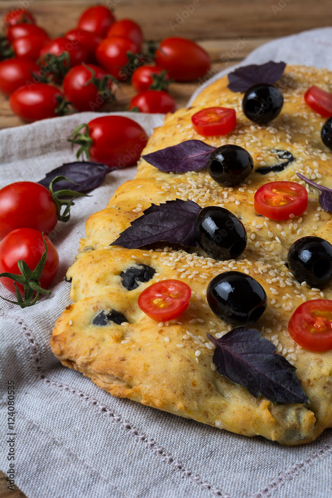 Italian bread focaccia with olive, basil and cherry tomato Italian bread focaccia with olive, basil and cherry tomato