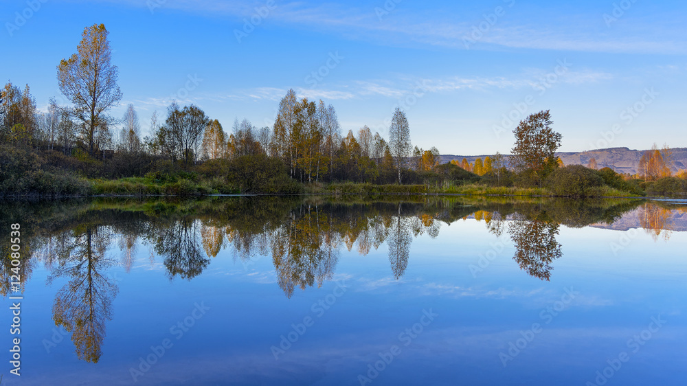 River landscape with multicolored fall trees River landscape with multicolored fall trees