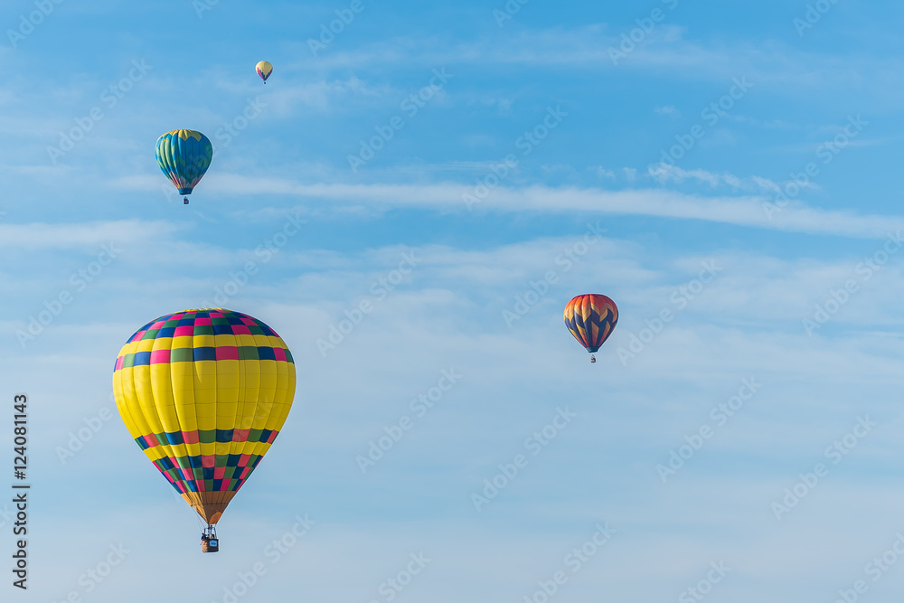 This is a photo of a beautiful hot air balloon slowly sailing through a calm blue sky. This is a photo of a beautiful hot air balloon slowly sailing through a calm blue sky.