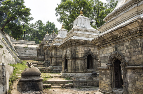 Votive temples and shrines in a row at Pashupatinath Temple, Kathmandu, Nepal - Sri Pashupatinath Temple located on the banks of the Bagmati River. photo