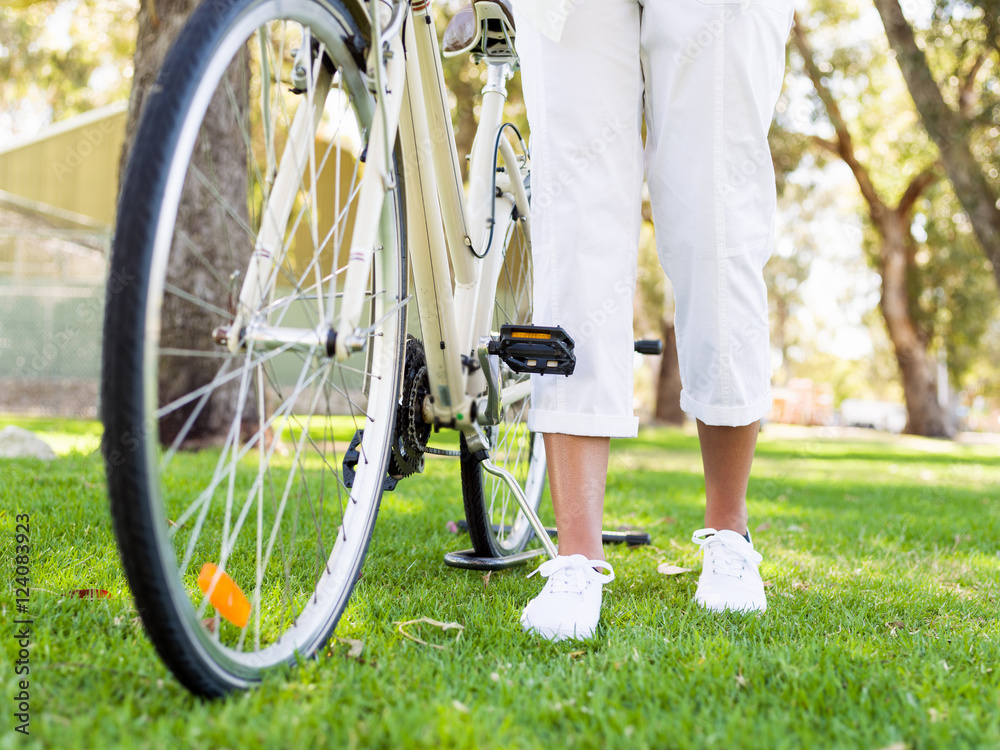 Naklejka premium Happy young woman with bicycle