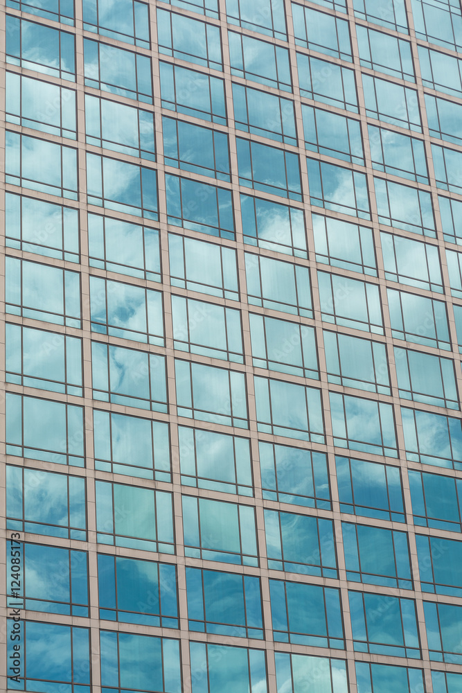 Building glass window pattern with a reflection of blue sky.